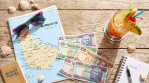 Planning how to visit Barbados on a budget with a map and local currency.